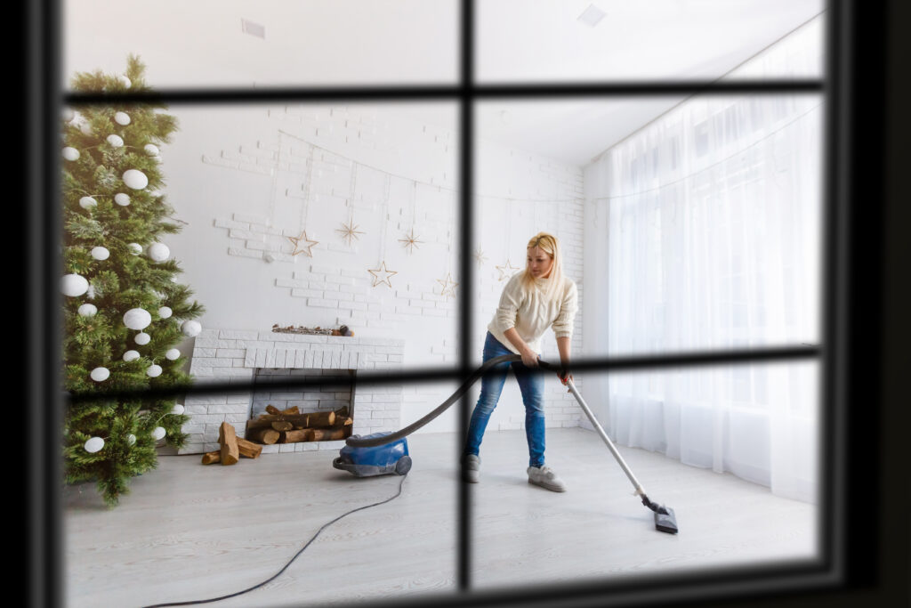 Homeowner cleaning living room after the holidays using a post-holiday cleaning checklist in Northern Virginia