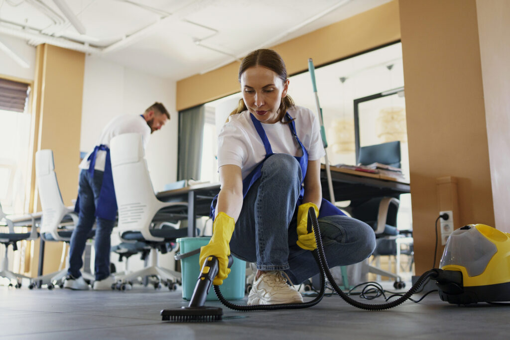Professional office cleaning service actively cleaning a modern workspace.
